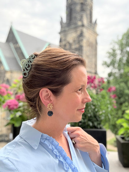 Blumen-Clips in Gold mit einer schwarzen Glitzerkugel