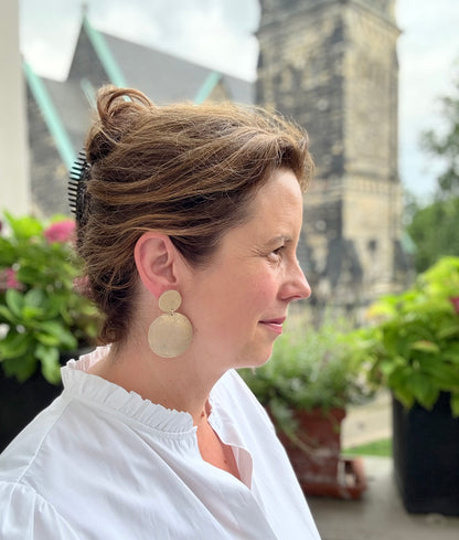 Zarte Ohrringe aus feinstem Leder mit einem runden Anhänger in edel schimmernden Goldtönen